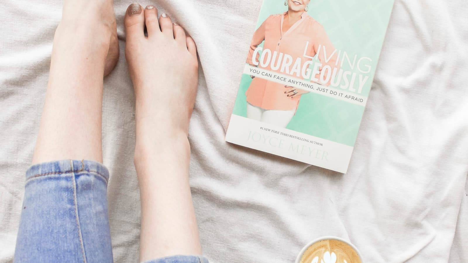 Flat lay of denim and clothing arranged on a tabletop.